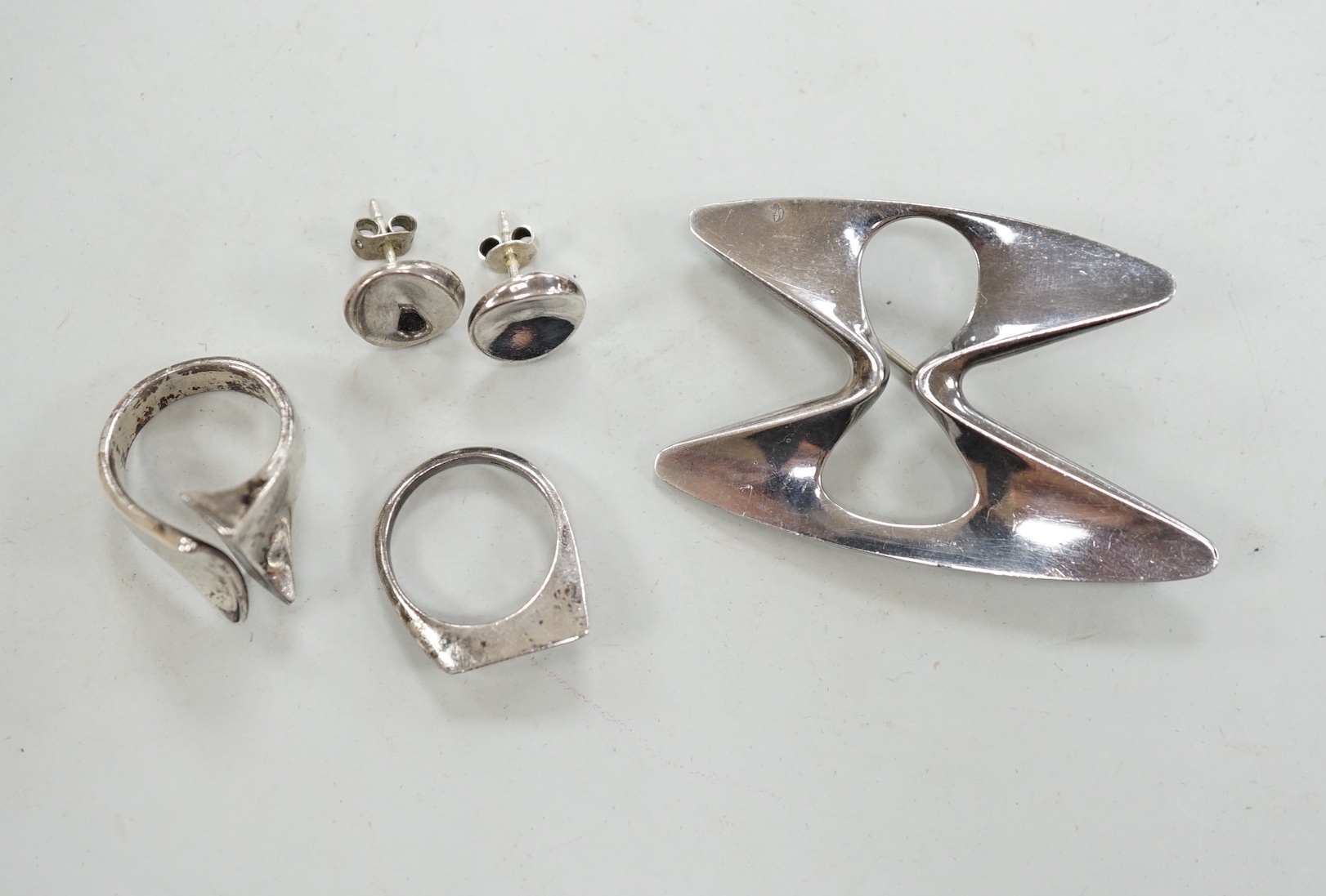 A Georg Jensen sterling free form brooch, design no. 369, a pair of Georg Jensen ear studs and two white metal rings.